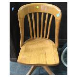 Vintage wooden swivel desk chair on casters