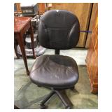 Black swiveling office chair on casters