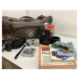 Assorted cameras, Treasure Island Mirage bag and