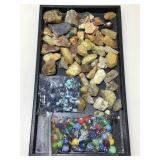 Assorted natural stone fragments and craft beads.
