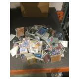 110+ sealed packs of cards!