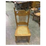 Antique oak pressed back bar chair, pressed cane