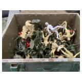 Green wood crate full of plastic army men of