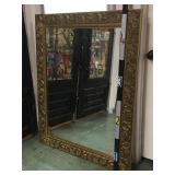Ornately framed beveled wall mirror, measuring