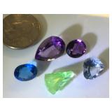 Various sizes and colors of gemstones, possibly