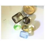 Various sizes and colors of gemstones, possibly