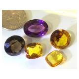 Various sizes and colors of gemstones, possibly