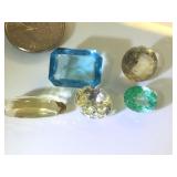 Various sizes and colors of gemstones, possibly