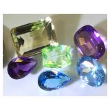 Various sizes and colors of gemstones, possibly