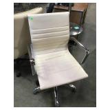 Cream colored swivel office chair on casters