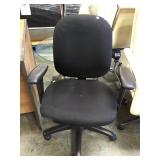 Black padded swivel office chair on casters