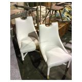 Pair of white rolling chairs on wheels from high