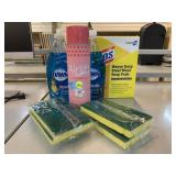 Assorted household cleaners and sponges.