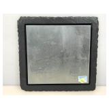 Etched metal boat design mounted on stone with