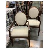 2 wood armchairs with cream upholstery
