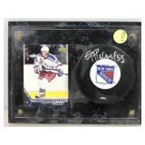 Signed hockey puck with rookie card on display