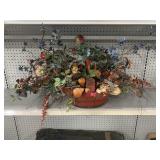 Faux floral table centerpiece in wood basket