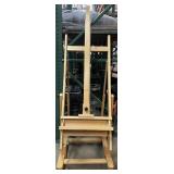 Wood easel In wheels, approx 78in tall