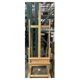 Wood easel In wheels, approx 78in tall