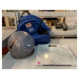 Soccer ball, backpack and taylor scale.