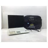 Sharp laptop with cord in bag.