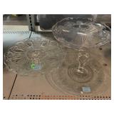 3 pressed glass food display stands.