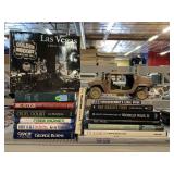 Assorted books and blue box model Humvee.