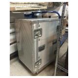Metal travel case in wheels, approx 21x28x34in
