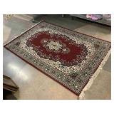 Red, Green and cream area rug, approx 65x98in