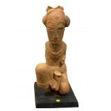 This image shows a terra-cotta sculpture from the