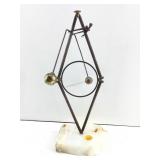 This is a Don DEMOTT brass balancing act art