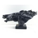 This is a glossy black horse head sculpture