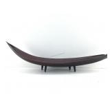 This is a large dark brown boat shaped wooden