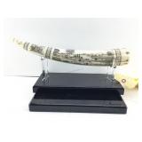 This is a vintage scrimshaw resin reproduction