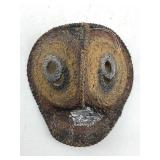 This appears to be a woven yam mask from the