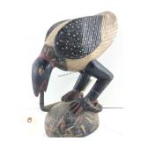 This is a handpainted wooden bird sculpture