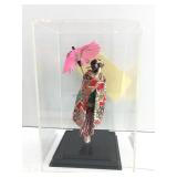 This item is a Japanese geisha doll enclosed in a