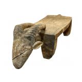 This is a carved wooden Dogon stool or bench