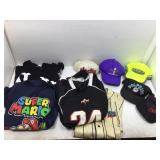 Assorted character shirts and hats. Some sports.