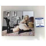 An autographed photo of Alexis Texas certified by