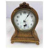 Small round top oak and brass mantle clock