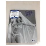An autographed picture of Nancy Kovack certified
