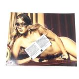An autographed photo of a young lady wearing a
