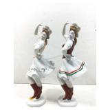 A pair of ceramic dancing figurines, both marked