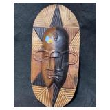 This Ghanaian wooden wall mask features a