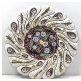 This Italian ceramic plate features a hand