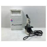 A modern microscope manufactured by TECNAR in