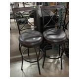 2 Metal high stools w/brown seats, has a few