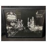 This framed print captures a classic nighttime