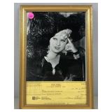 A framed photo of the famous May West along with